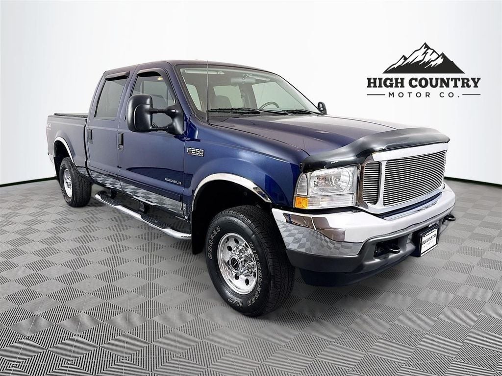 2002 Ford F-250SD XLT in Island Blue Clearcoat Metallic — front three-quarter view